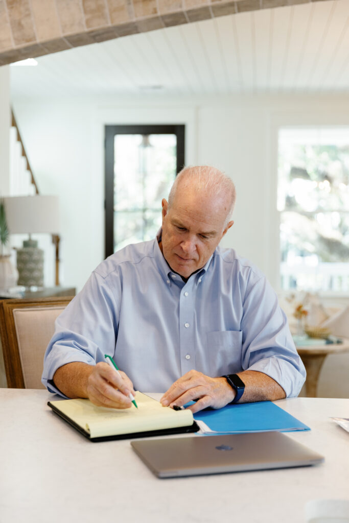 Bill Byrd working at the kitchen island helping clients decide Should I Sell My Home in 2025 or Wait?